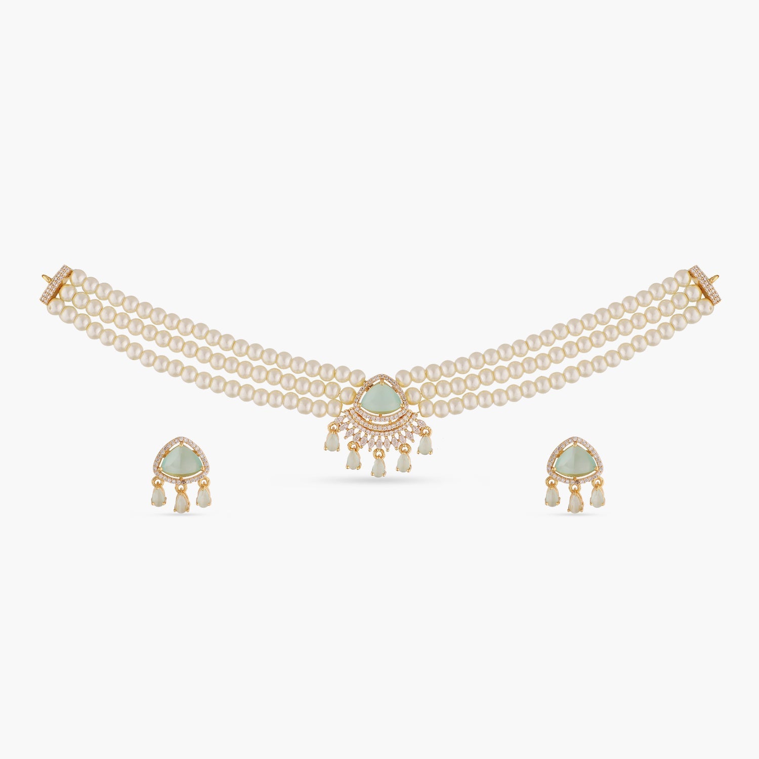 A picture of an Indian artificial jewelry set: a three layered pearl necklace and earrings featuring Cubic Zirconia and green gemstones.