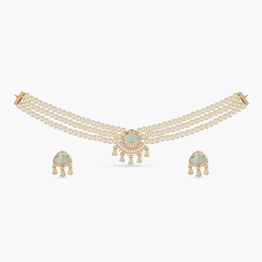 A picture of an Indian artificial jewelry set: a three layered pearl necklace and earrings featuring Cubic Zirconia and green gemstones.